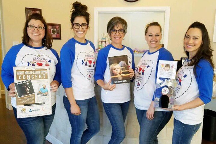 Team members holding signs for concert event