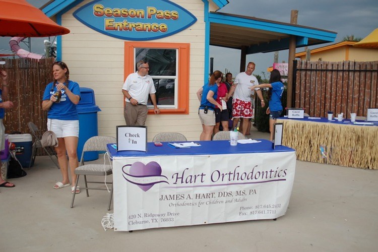 Hart orthodontics table at water park entrance