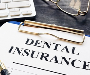 Dental insurance form on clipboard on desk