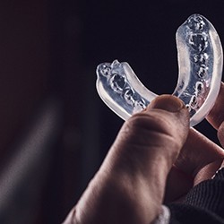 Patient holding up clear mouthguard