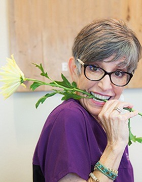 Christy holding rose in teeth