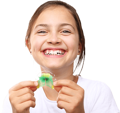 Little girl holding oral appliance