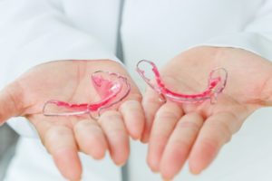 a person holding retainers