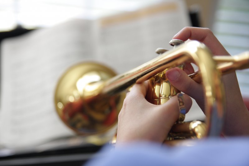 Closeup of child playing trumpet