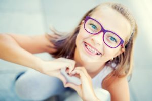 Girl with braces smiles during National Children’s Dental Health Month