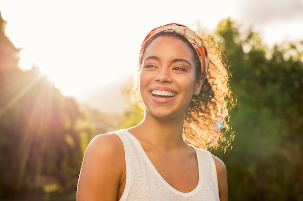 beautiful woman smiling at sunset