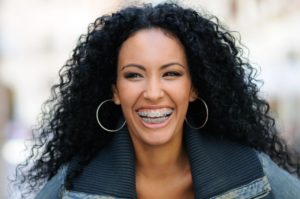 a woman smiling happily with braces