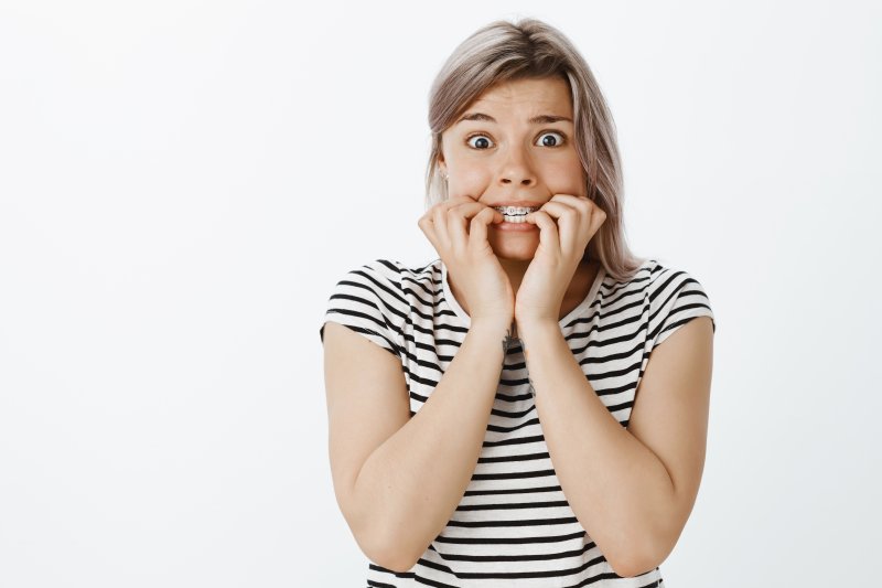 Worried woman with braces.