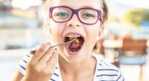 Child with braces eating their lunch